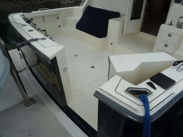 Slide: The Image of 2006 Sabre 38 Express boat deck with seating and storage compartments. - 6