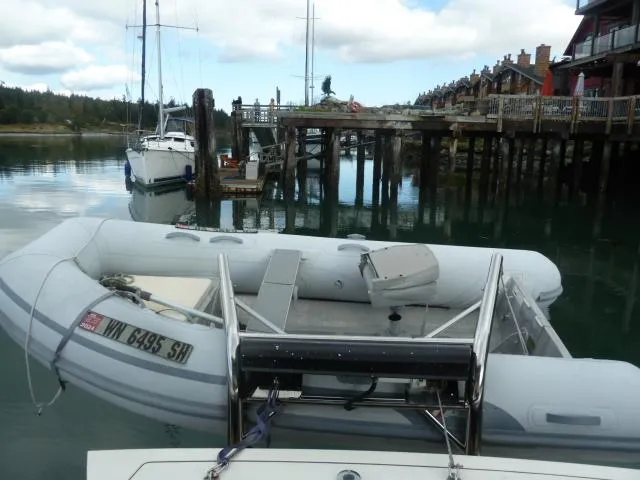 Slide: The Image of 2006 Sabre 38 Express docked with inflatable boat in scenic marina setting. - 9