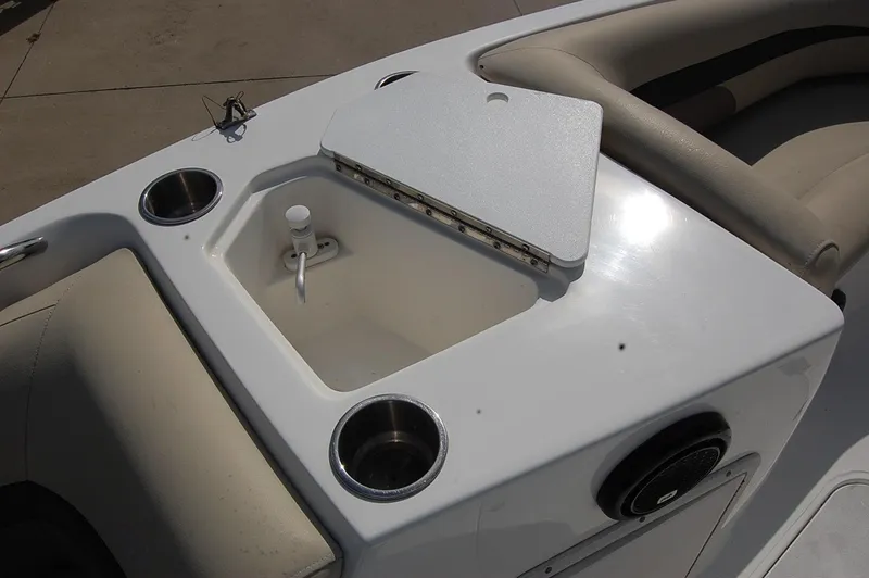 Slide: The Image of 2019 Hurricane SunDeck Sport 188 OB boat interior with cup holders and storage compartment. - 10