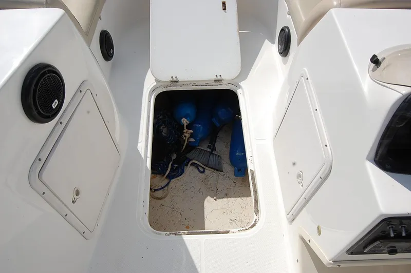 Slide: The Image of 2019 Hurricane SunDeck Sport 188 OB boat storage compartment with equipment. - 11