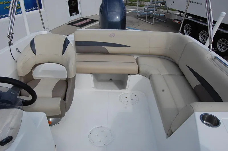 Slide: The Image of 2019 Hurricane SunDeck Sport 188 OB boat interior with beige seating and steering console. - 13