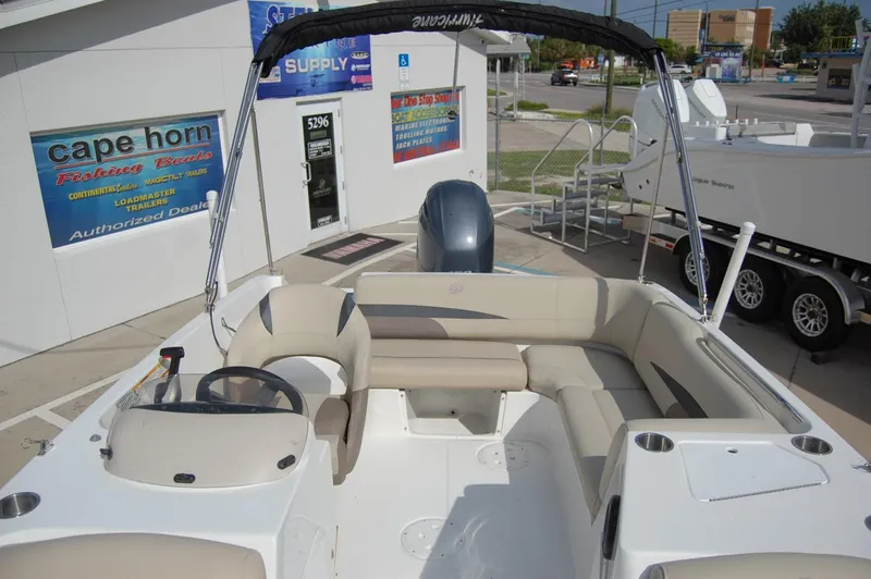 Slide: The Image of 2019 Hurricane SunDeck Sport 188 OB boat with seating and steering console, displayed at dealership. - 5