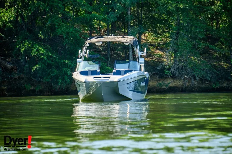 Slide: The Image of 2024 MasterCraft X24 boat on a serene lake, surrounded by lush greenery. - 4