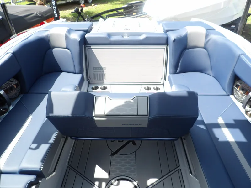 Slide: The Image of 2024 MasterCraft X24 boat interior with blue seating and modern design. - 8