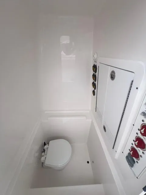 Slide: The Image of 2024 Contender 28 Tournament boat interior with compact marine toilet. - 14