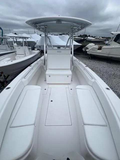 Slide: The Image of 2024 Contender 28 Tournament boat with spacious deck and seating, docked under cloudy skies. - 5