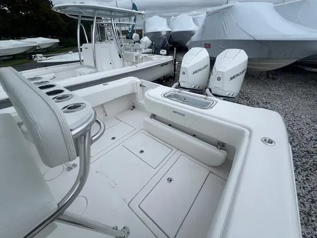 Slide: The Image of 2024 Contender 28 Tournament boat with dual Mercury engines, docked and ready for fishing. - 6