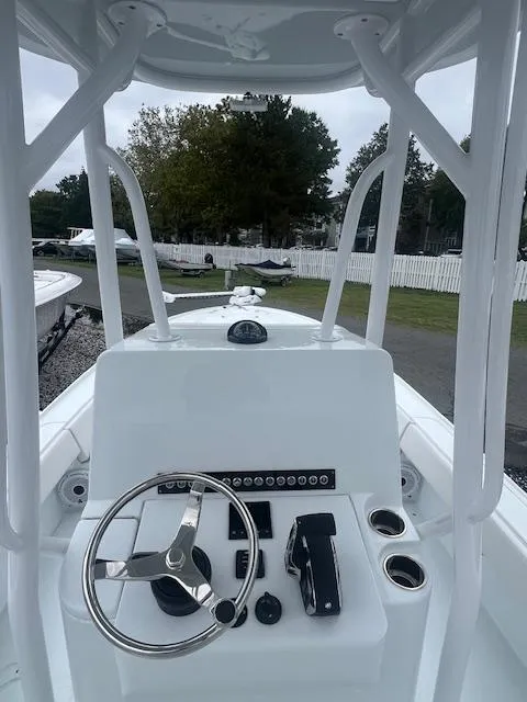 Slide: The Image of 2024 Contender 26 Bay boat console with steering wheel and controls. - 3