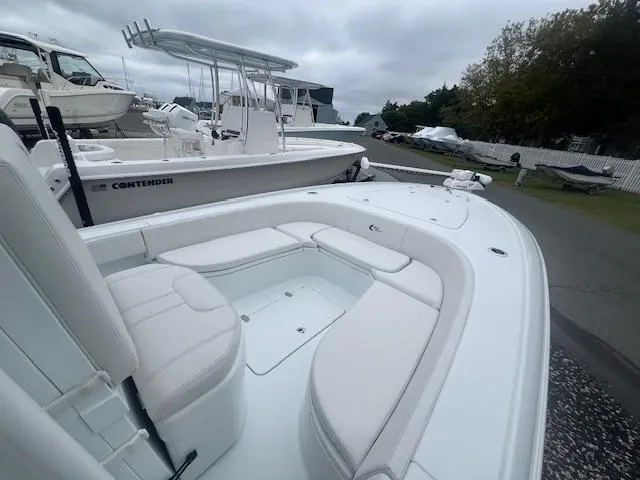 Slide: The Image of 2024 Contender 26 Bay boat with sleek white seating and spacious deck. - 5