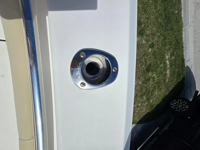 Slide: The Image of Close-up of a 2015 Cobia 296 Center Console boat detail, showing a metal fitting. - 10