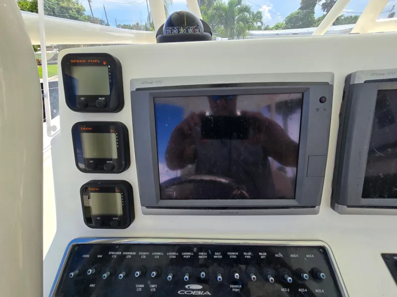 Slide: The Image of 2015 Cobia 296 Center Console dashboard with Garmin GPS and control panels. - 14