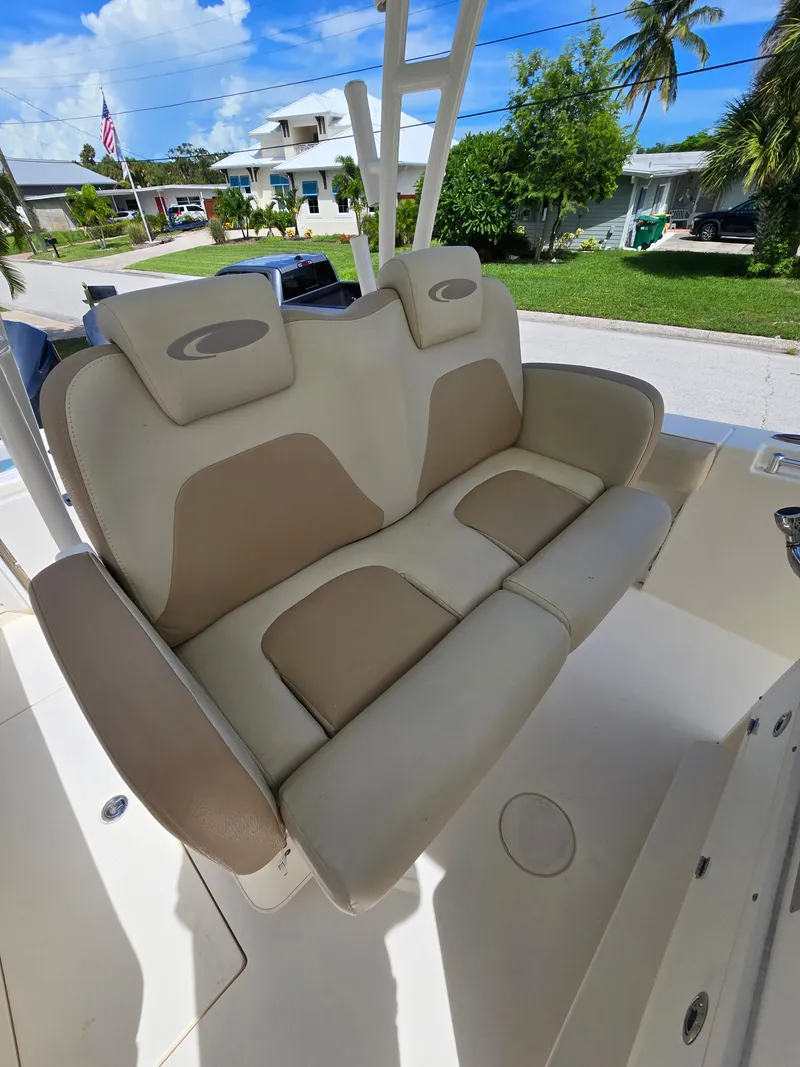 Slide: The Image of 2015 Cobia 296 Center Console boat seat with beige and cream upholstery. - 17