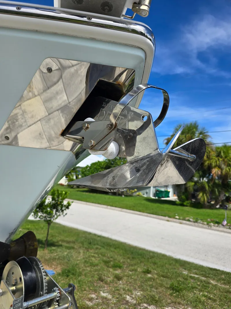 Slide: The Image of 2015 Cobia 296 Center Console boat anchor detail under clear blue sky. - 2