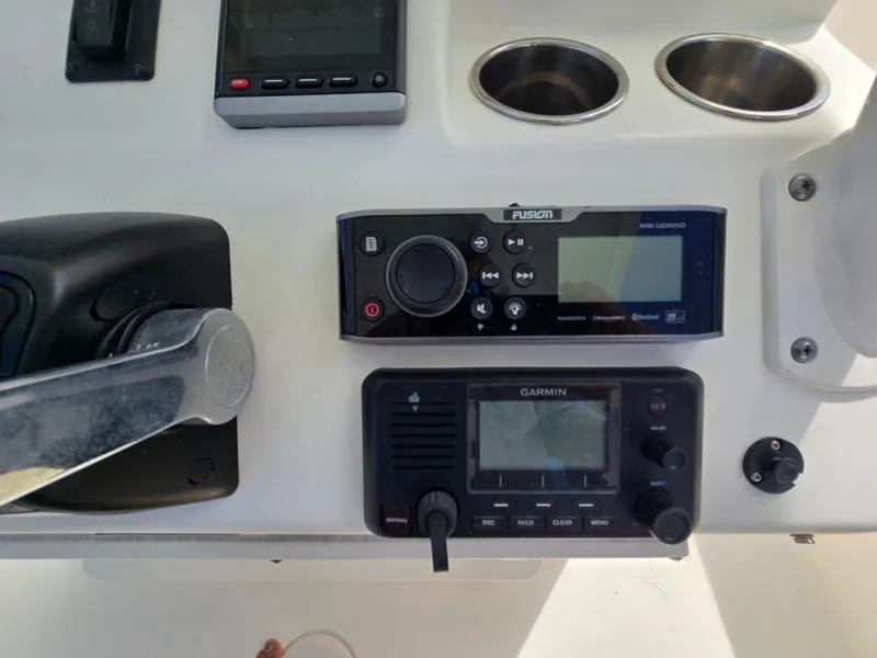 Slide: The Image of Control panel of a 2015 Cobia 296 Center Console with Garmin and Fusion devices. - 27