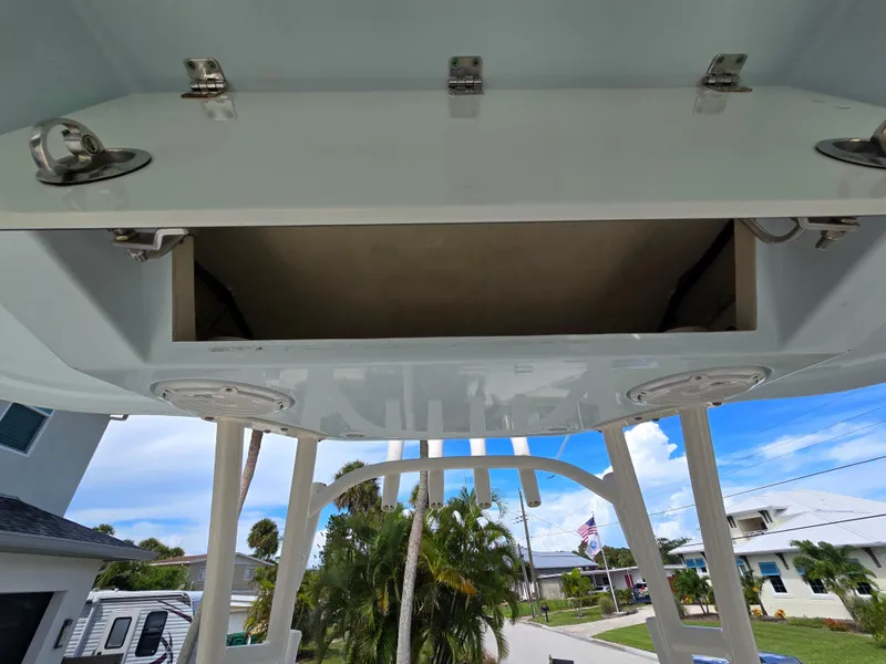 Slide: The Image of Open storage compartment on a 2015 Cobia 296 Center Console boat. - 29