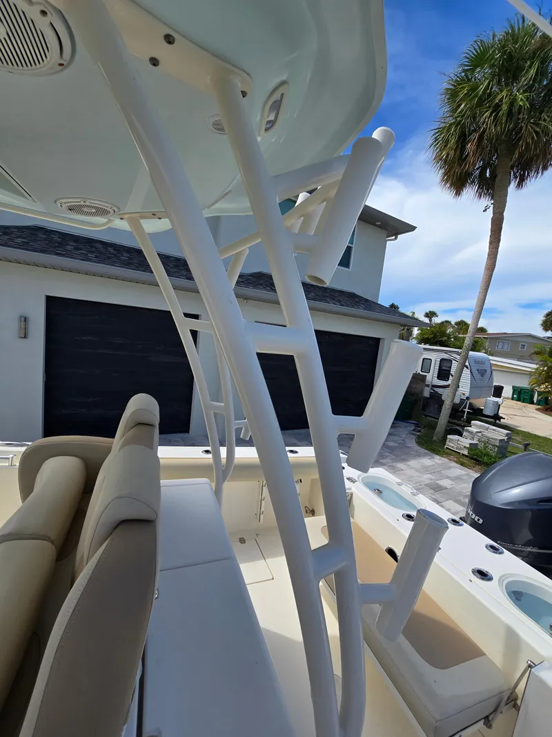 Slide: The Image of 2015 Cobia 296 Center Console boat interior with seating and rod holders. - 30