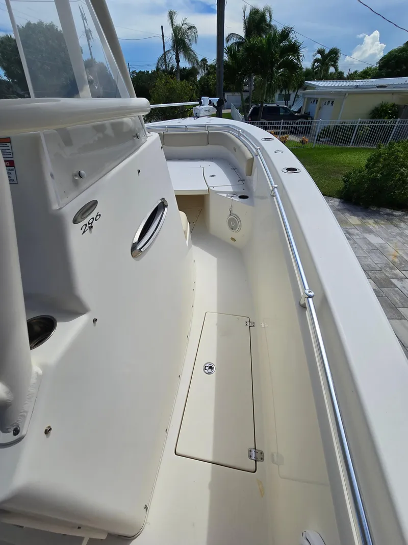 Slide: The Image of 2015 Cobia 296 Center Console boat, side view, white deck, outdoor setting. - 32
