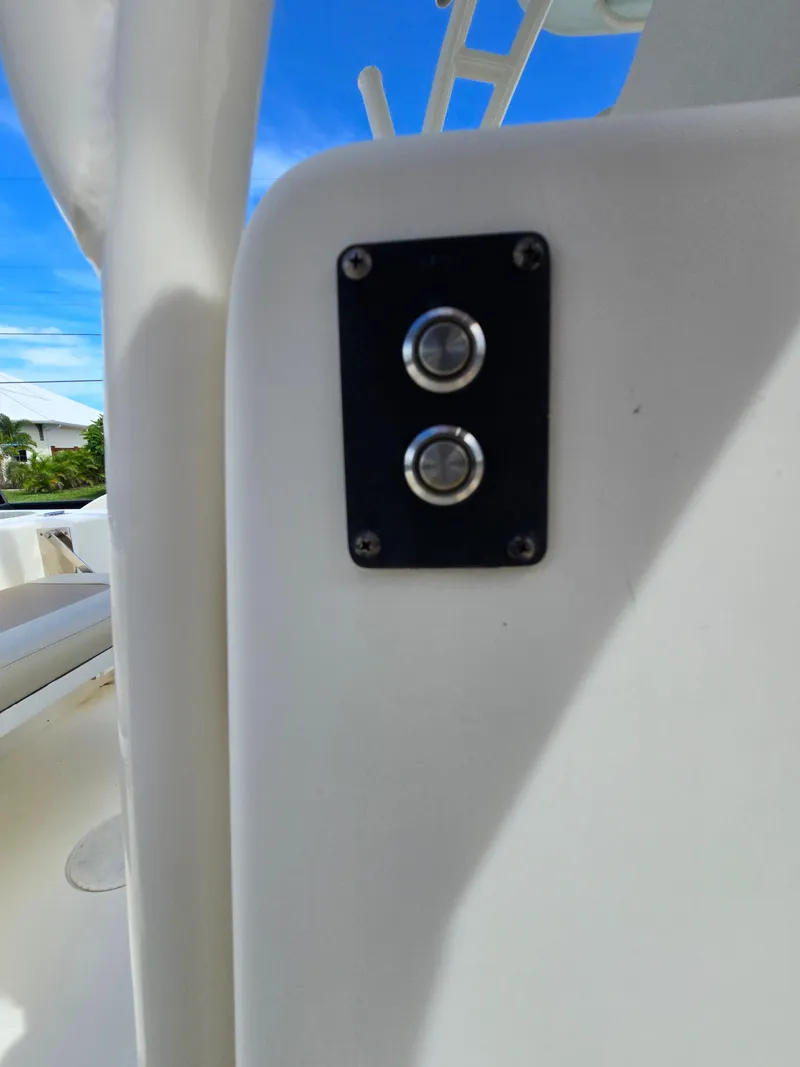 Slide: The Image of Close-up of control buttons on a 2015 Cobia 296 Center Console boat. - 34