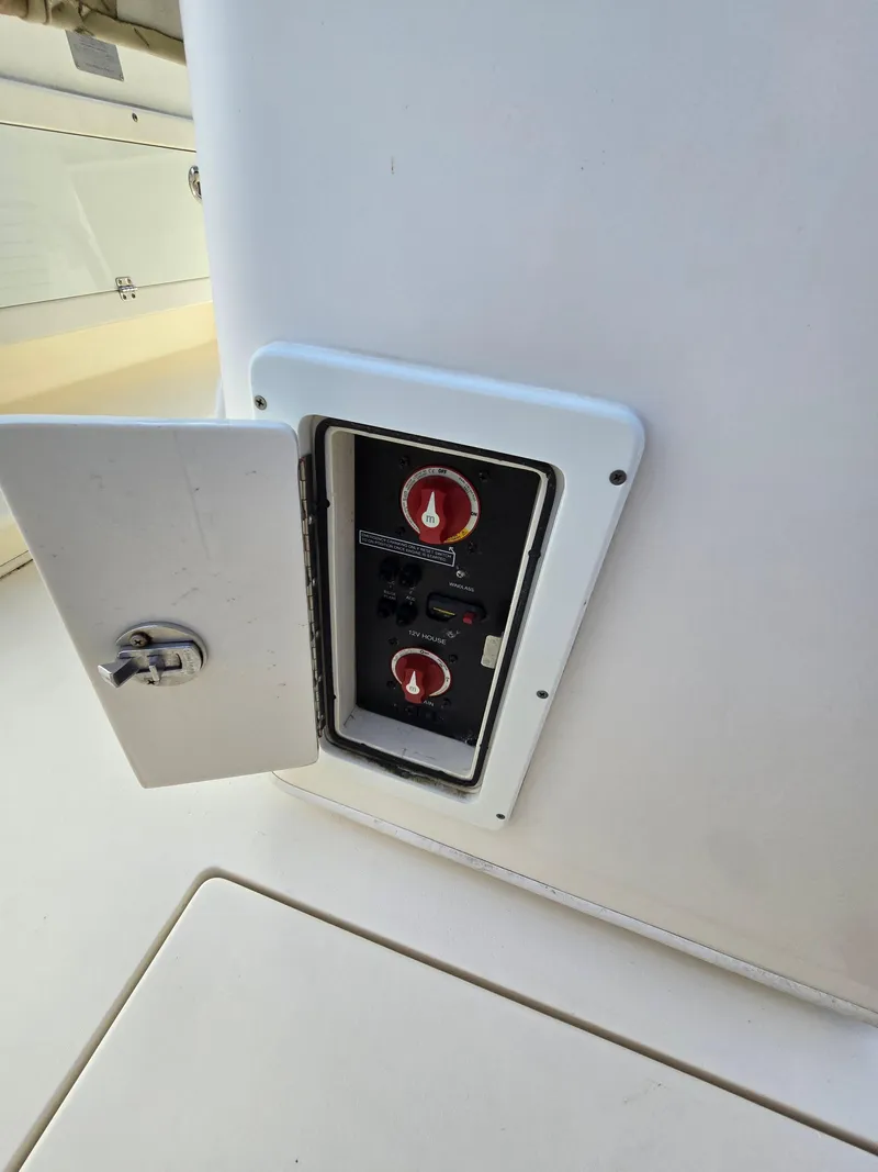 Slide: The Image of 2015 Cobia 296 Center Console battery switch panel with open access door. - 37