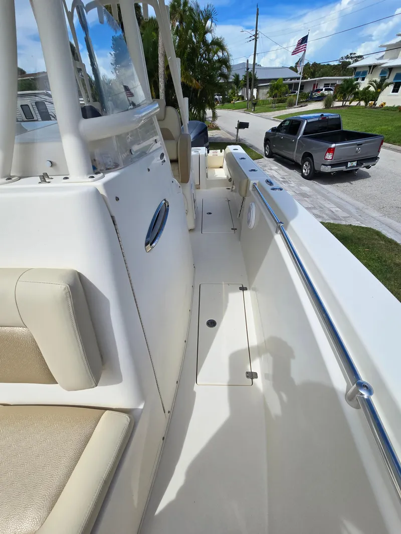 Slide: The Image of 2015 Cobia 296 Center Console boat interior with seating and console view. - 39