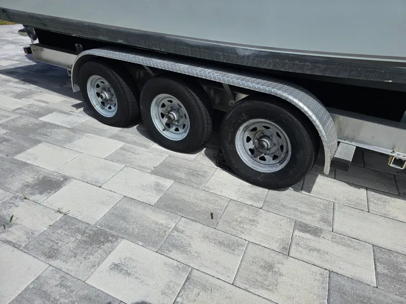 Slide: The Image of Trailer with three wheels for 2015 Cobia 296 Center Console boat. - 4