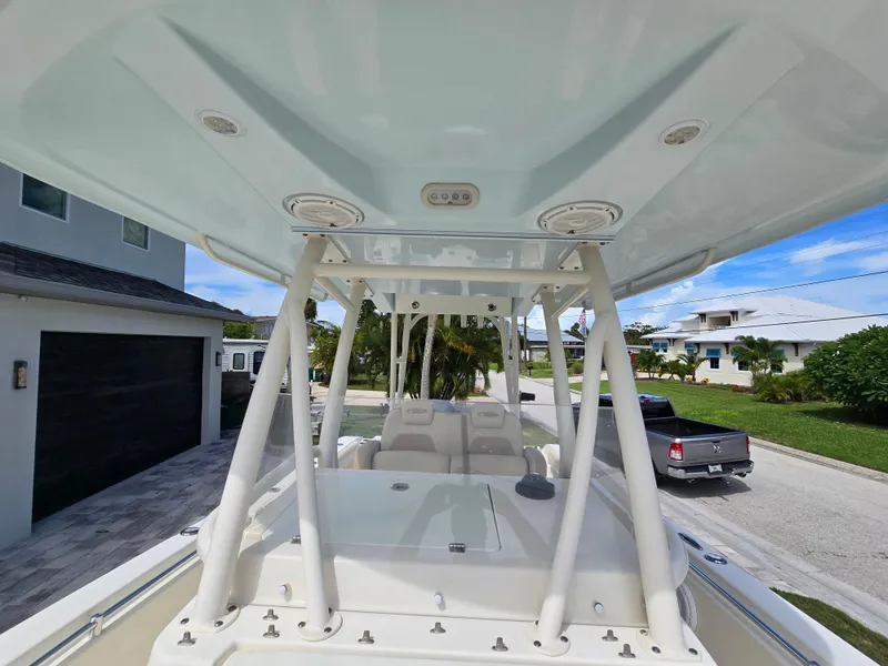 Slide: The Image of 2015 Cobia 296 Center Console boat parked in a residential driveway. - 41