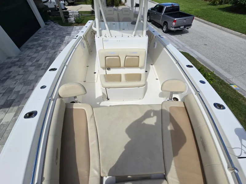 Slide: The Image of 2015 Cobia 296 Center Console boat interior with seating and console view. - 44