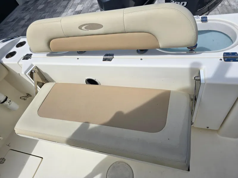 Slide: The Image of 2015 Cobia 296 Center Console boat seating area with beige cushions. - 45
