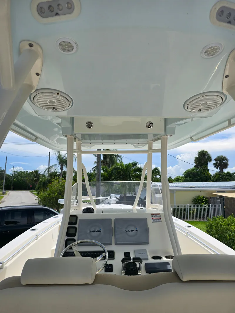 Slide: The Image of 2015 Cobia 296 Center Console boat interior with steering wheel and electronics. - 48