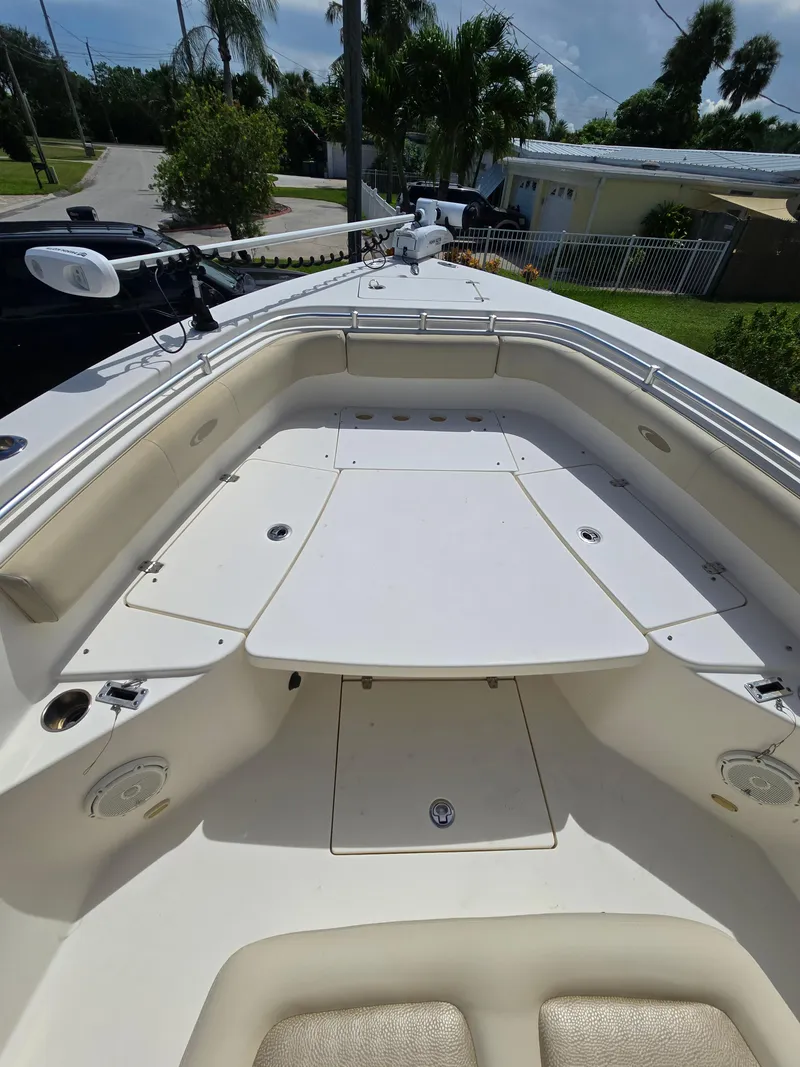 Slide: The Image of 2015 Cobia 296 Center Console boat deck with seating and storage compartments. - 5