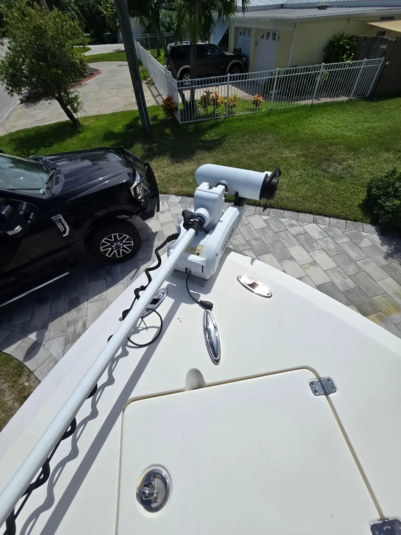 Slide: The Image of 2015 Cobia 296 Center Console boat with trolling motor on driveway. - 6