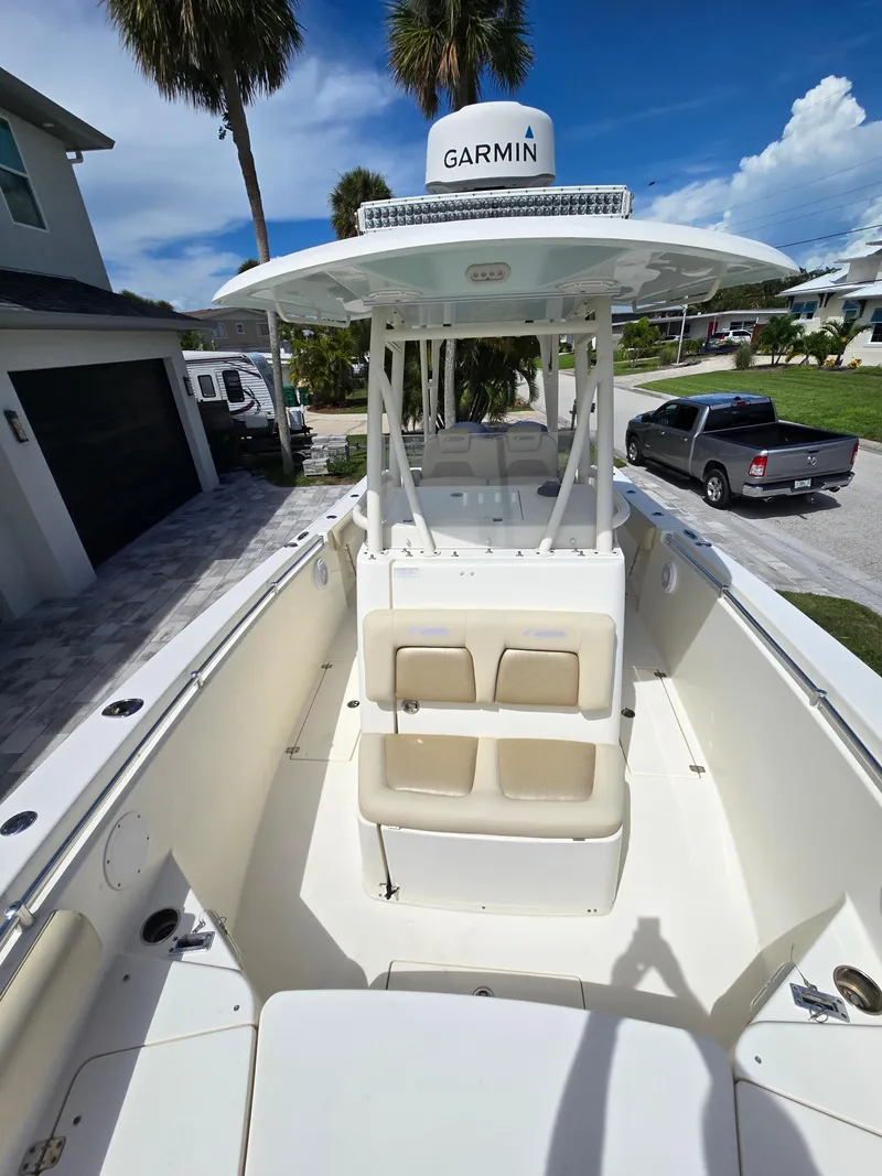 Slide: The Image of 2015 Cobia 296 Center Console boat with Garmin equipment, parked in a residential driveway. - 8