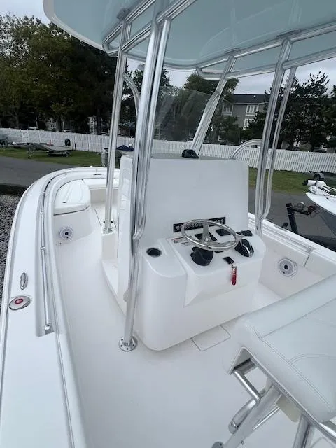 Slide: The Image of 2024 Contender 24 Sport boat interior with steering console and seating. - 3