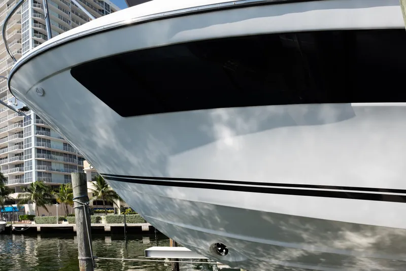 Slide: The Image of 2024 Jeanneau Leader 9.0WA S2 boat docked near waterfront buildings. - 16