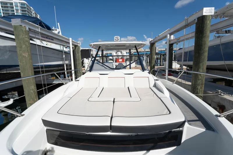 Slide: The Image of 2024 Jeanneau Leader 9.0WA S2 boat docked, featuring spacious sunbathing area. - 18