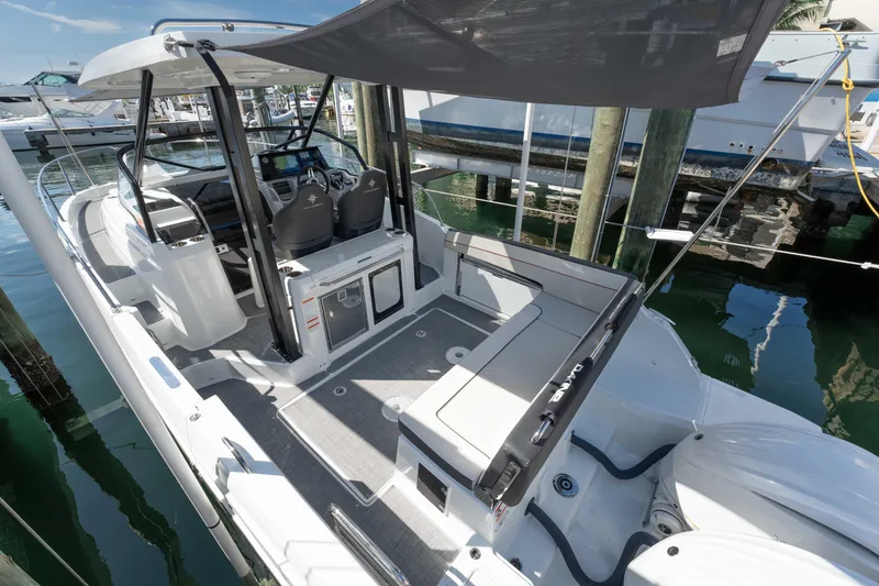Slide: The Image of 2024 Jeanneau Leader 9.0WA S2 boat interior with seating and canopy. - 21