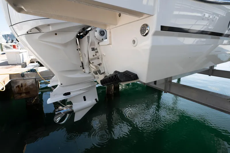 Slide: The Image of 2024 Jeanneau Leader 9.0WA S2 boat engine and stern view at dock. - 23