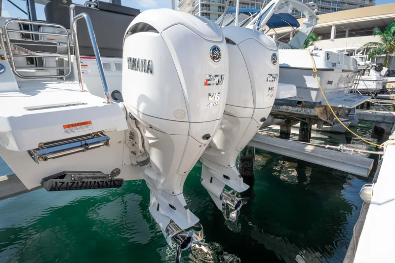 Slide: The Image of 2024 Jeanneau Leader 9.0WA S2 with twin Yamaha outboard engines docked at marina. - 26