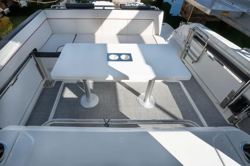 Slide: The Image of 2024 Jeanneau Leader 9.0WA S2 boat deck with seating and table. - 36