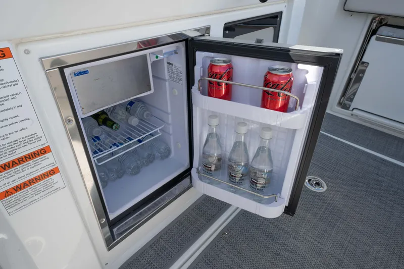 Slide: The Image of Mini fridge on Jeanneau Leader 9.0WA S2 boat, stocked with drinks, 2024 model. - 43