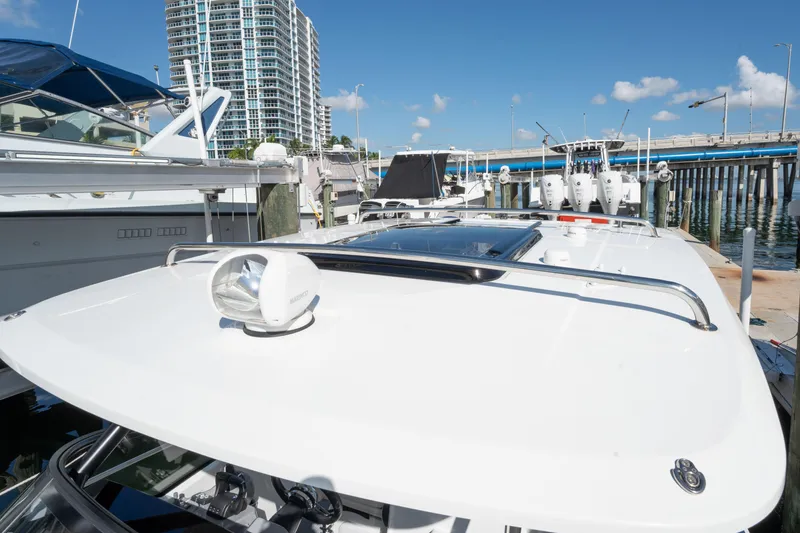 Slide: The Image of 2024 Jeanneau Leader 9.0WA S2 docked at marina with cityscape background. - 47
