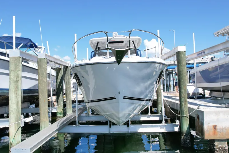 Slide: The Image of 2024 Jeanneau Leader 9.0WA S2 boat docked at marina, front view. - 5