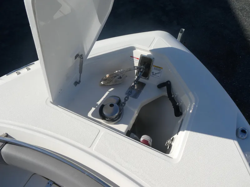 Slide: The Image of 2024 Boston Whaler 280 Outrage anchor storage compartment with open hatch. - 10
