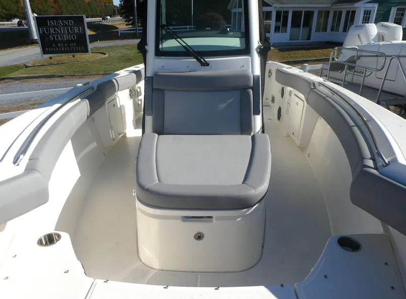 Slide: The Image of 2024 Boston Whaler 280 Outrage boat interior with cushioned seating. - 11