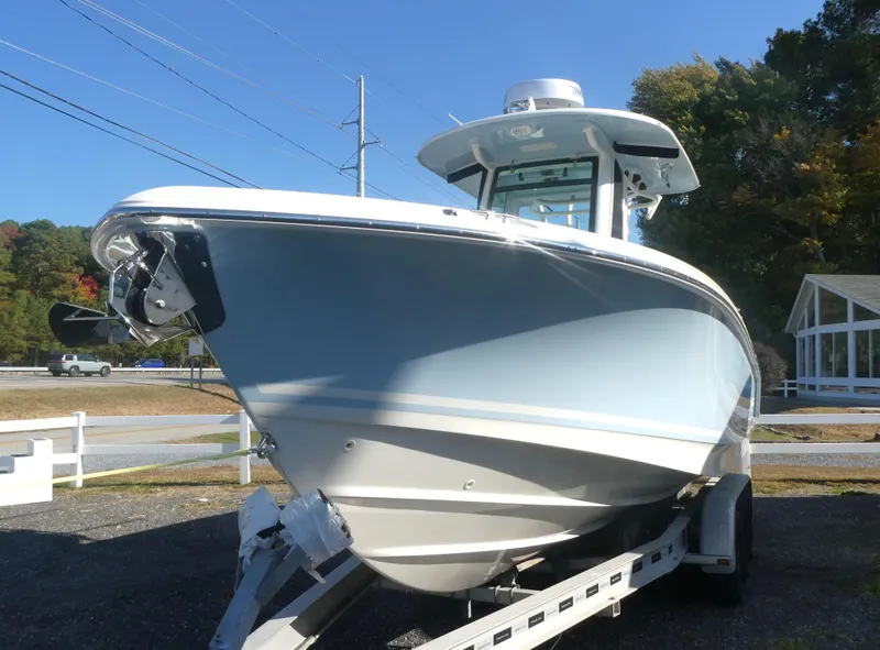Slide: The Image of 2024 Boston Whaler 280 Outrage boat on trailer, displayed outdoors. - 4