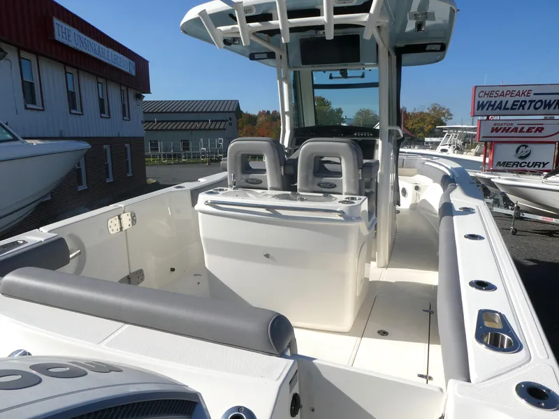 Slide: The Image of 2024 Boston Whaler 280 Outrage boat interior with seating and console. - 5