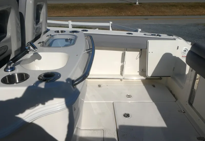 Slide: The Image of 2024 Boston Whaler 280 Outrage boat interior with fishing amenities and storage. - 8