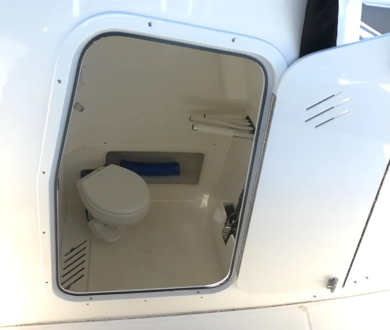 Slide: The Image of 2024 Boston Whaler 280 Outrage boat interior with compact marine toilet. - 9