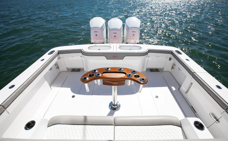 Slide: The Image of 2022 Valhalla Boatworks 46 Center Console, spacious deck with triple engines, on open water. - 11