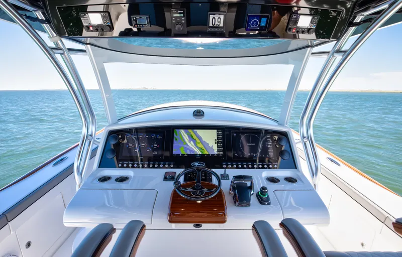 Slide: The Image of 2022 Valhalla Boatworks 46 Center Console helm with advanced navigation system on open water. - 12